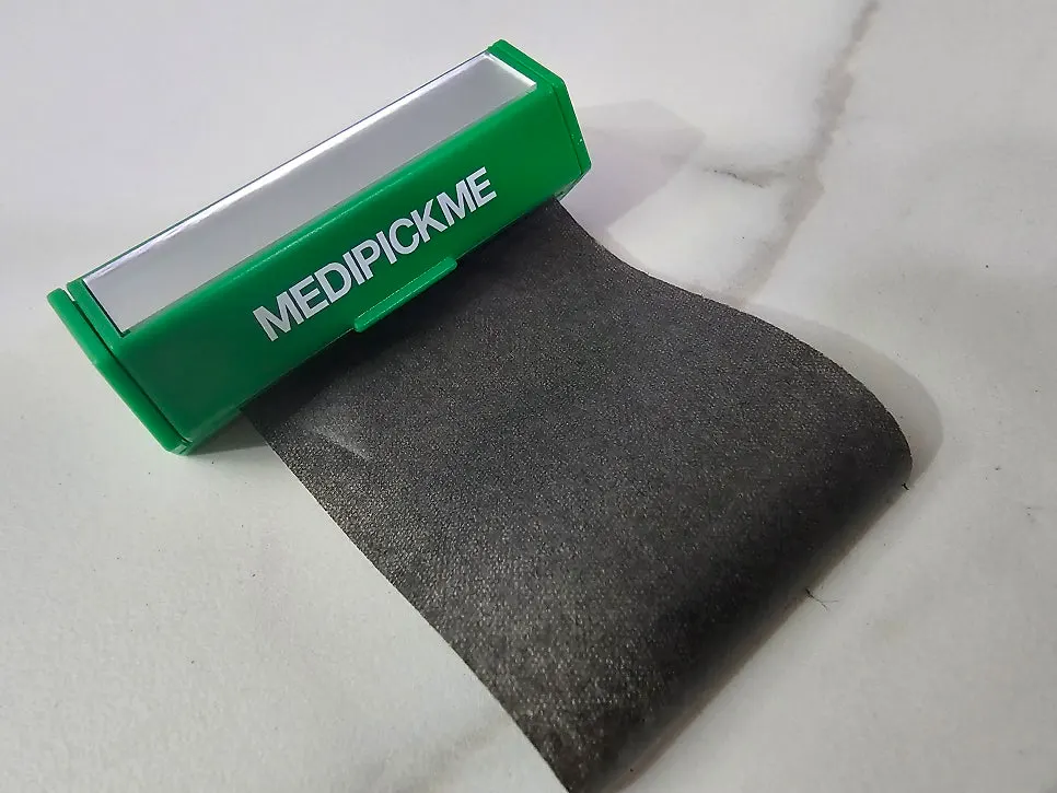 Compact oil blotting paper placed in a makeup pouch