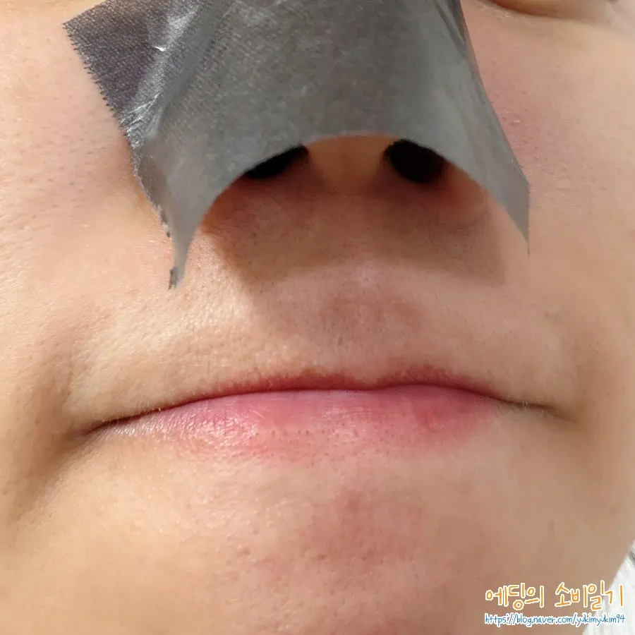 Using blotting paper on an oily forehead