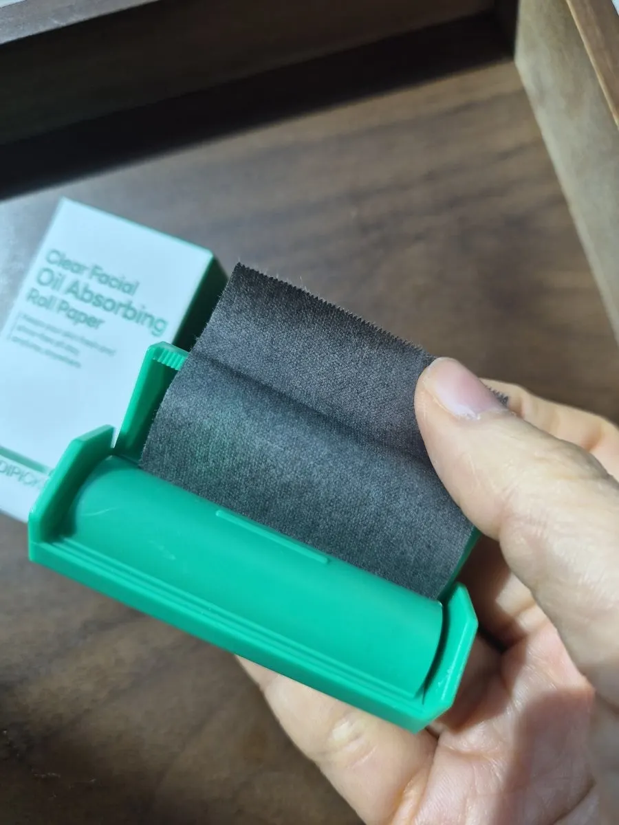 Blotting paper pressed onto oil over makeup