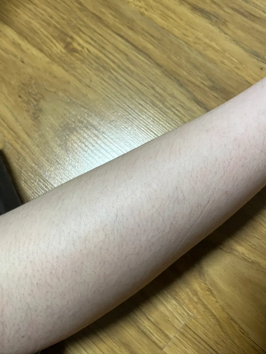 Hair removal cream applied to a leg