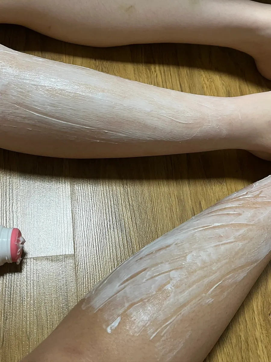 Spreading the hair removal cream from the tube opening