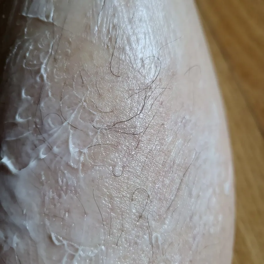 Applying the hair removal cream to the calf