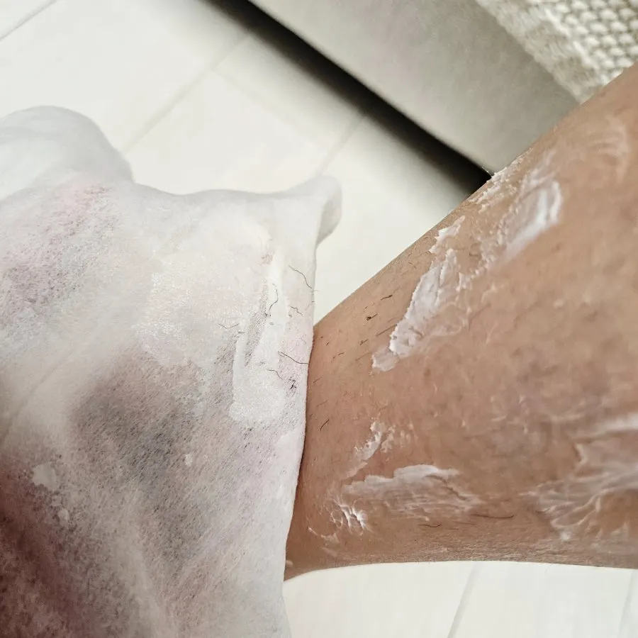 Wiping off the hair removal cream with tissue to finish