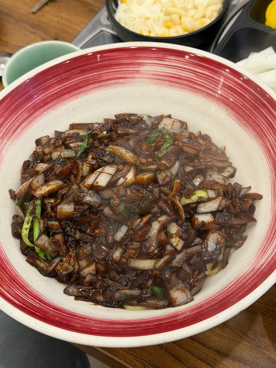 A forkful of ganjjajang with sauce blended in