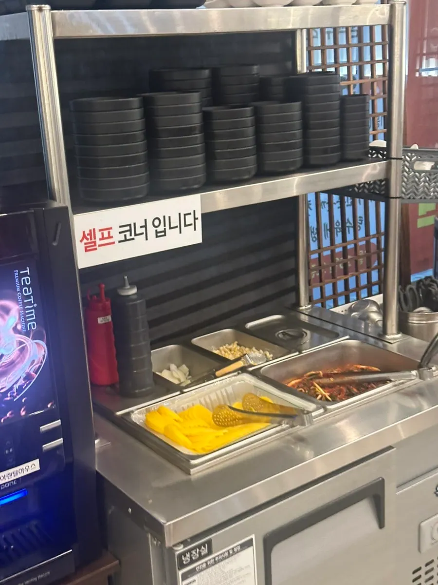 Mayway self-serve bar with pickled radish, scallion kimchi, and macaroni salad