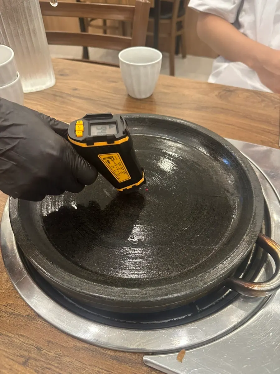 Checking the stone griddle's temperature before serving stone-griddle jjajang