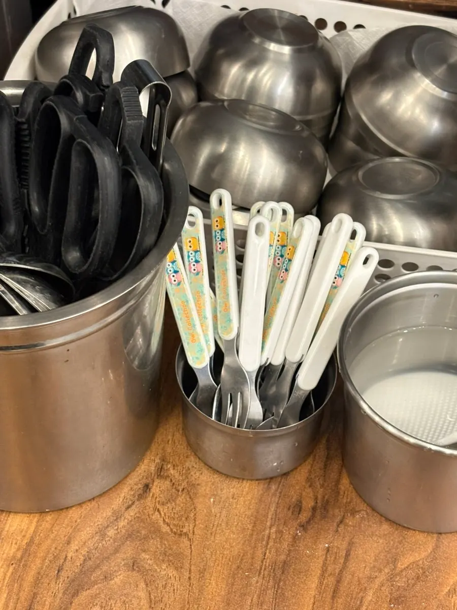 Baby-sized fork and spatula among children's tableware