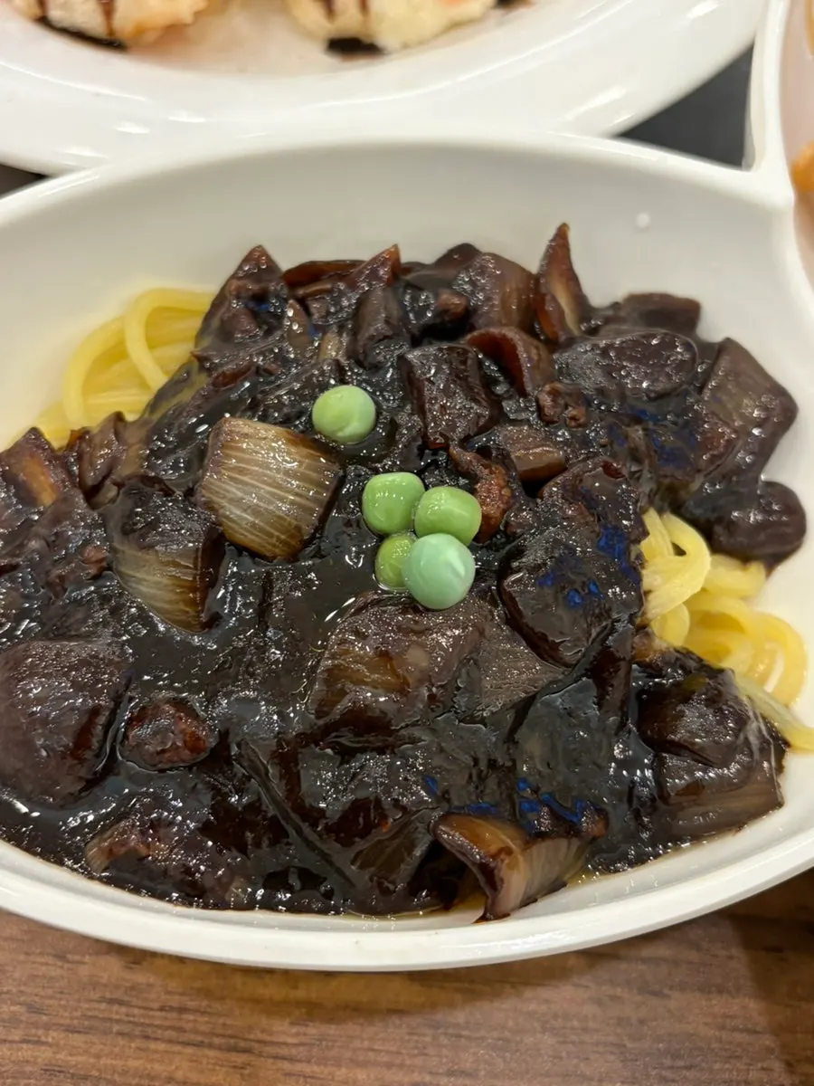Jjajang sauce and noodles with large onion chunks