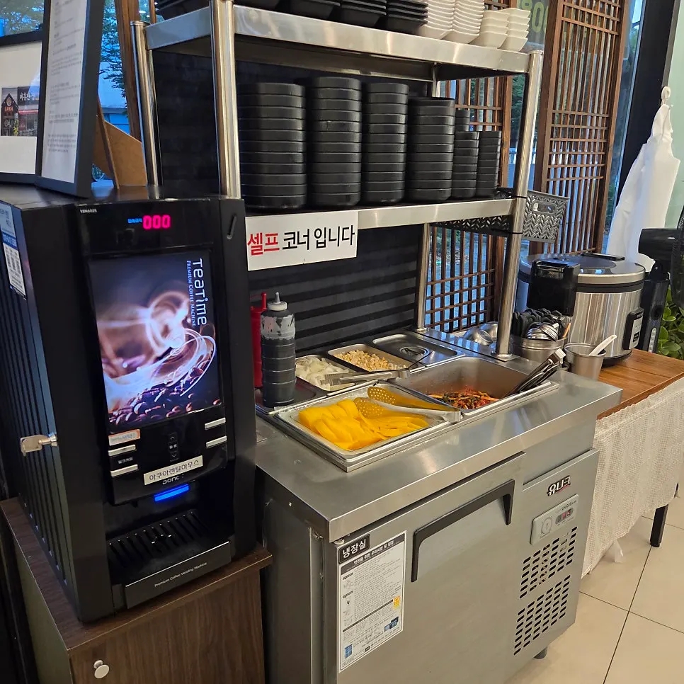 Self-serve corner with pickled radish, onion, and side dishes