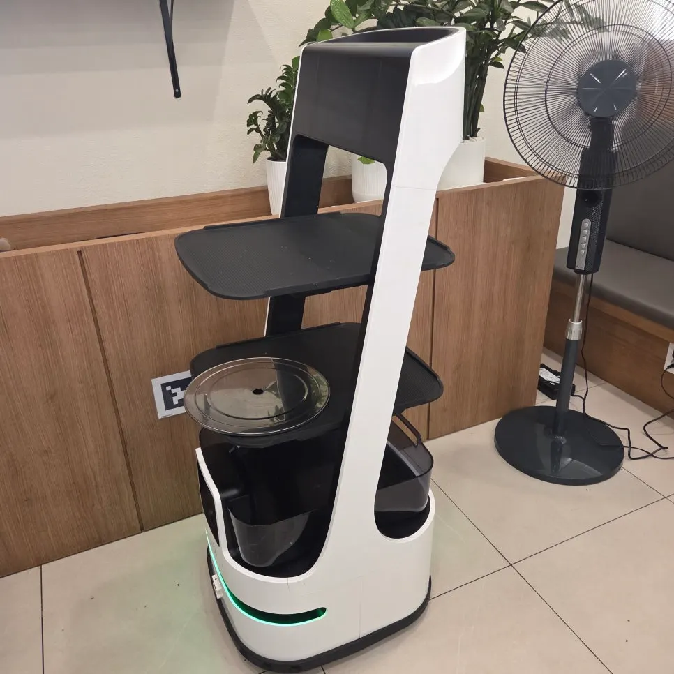 Serving robot resting on one side of the restaurant