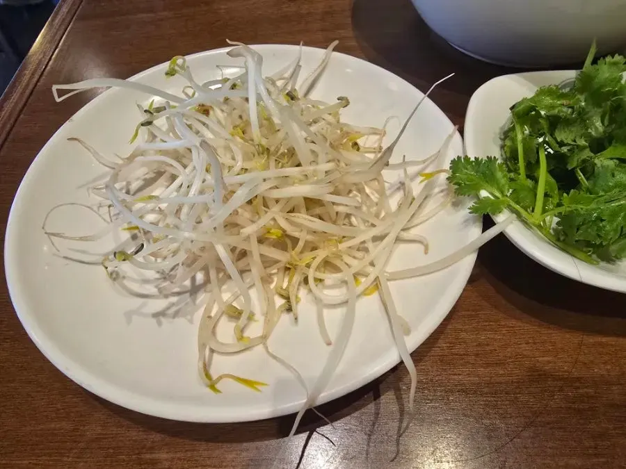 Close-up of the red broth in the spicy beef pho