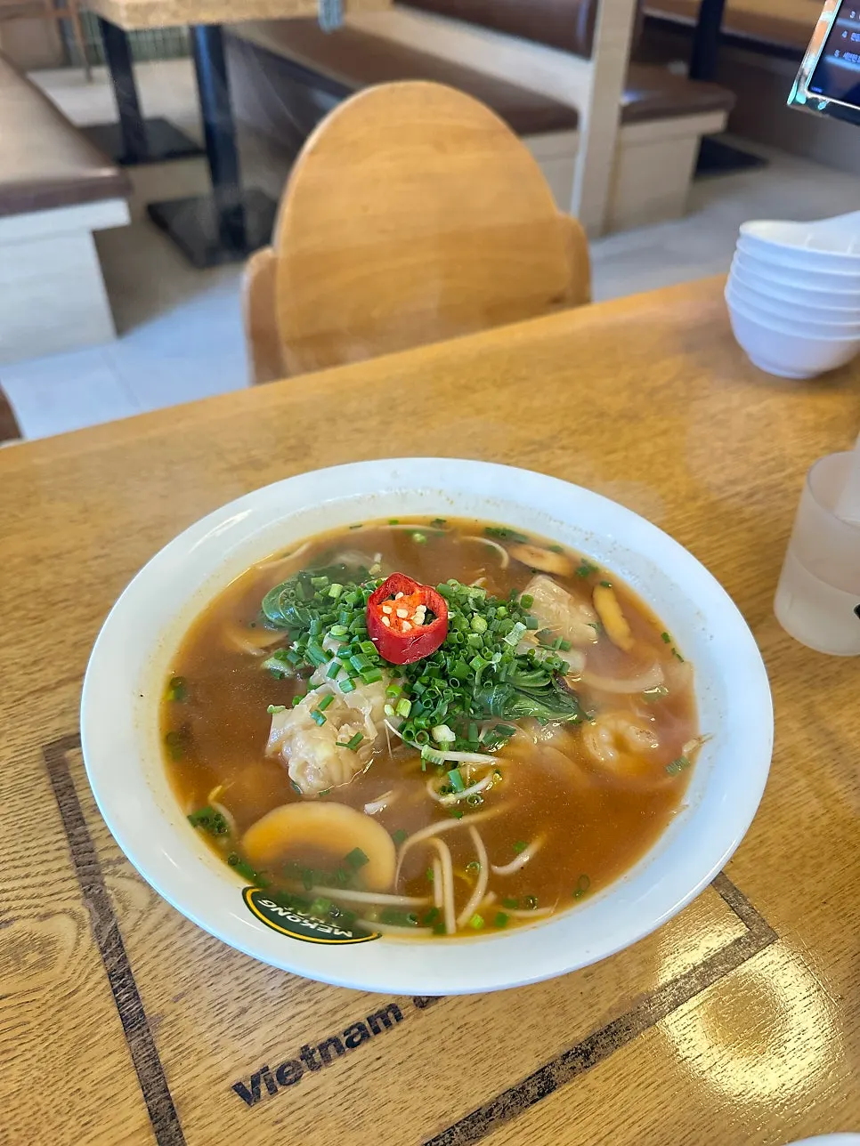 A shrimp wonton lifted up with a spoon