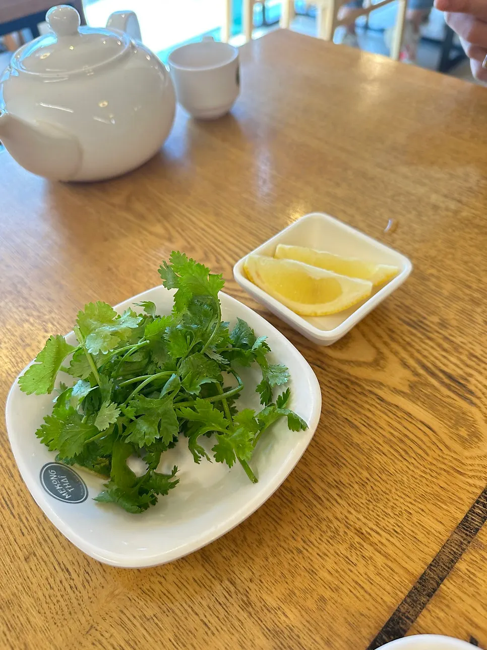 Plate of cilantro, cheongyang chili, and lemon served on request