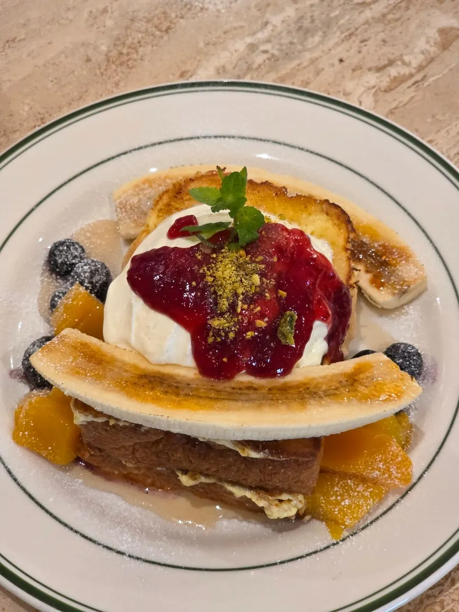 French toast topped with banana brûlée and cream