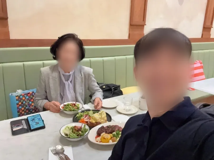 Table set with steak, eggs Benedict, and salad
