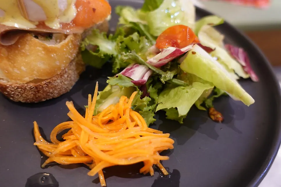 Fresh salad served alongside the eggs Benedict