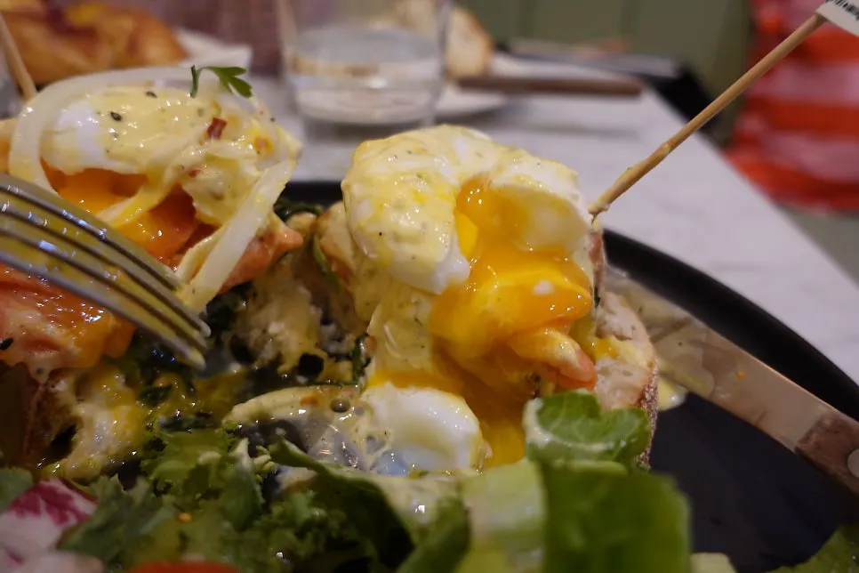 Plate of salmon eggs Benedict after being cut into