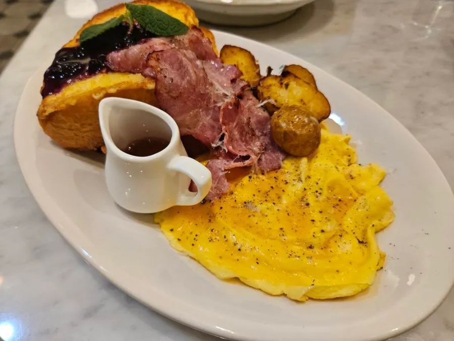 Plate with scrambled eggs, bacon, and baby potatoes