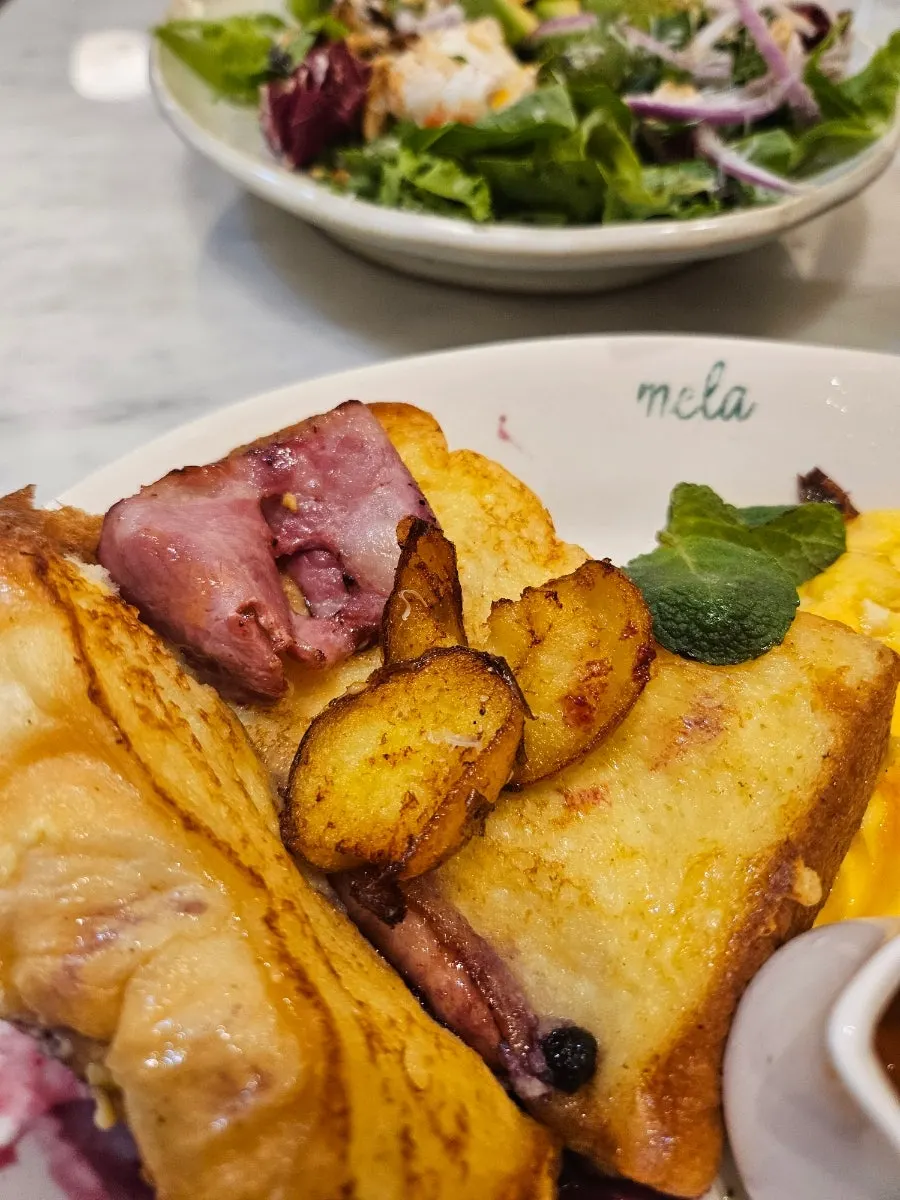A bite of French toast topped with blueberry compote