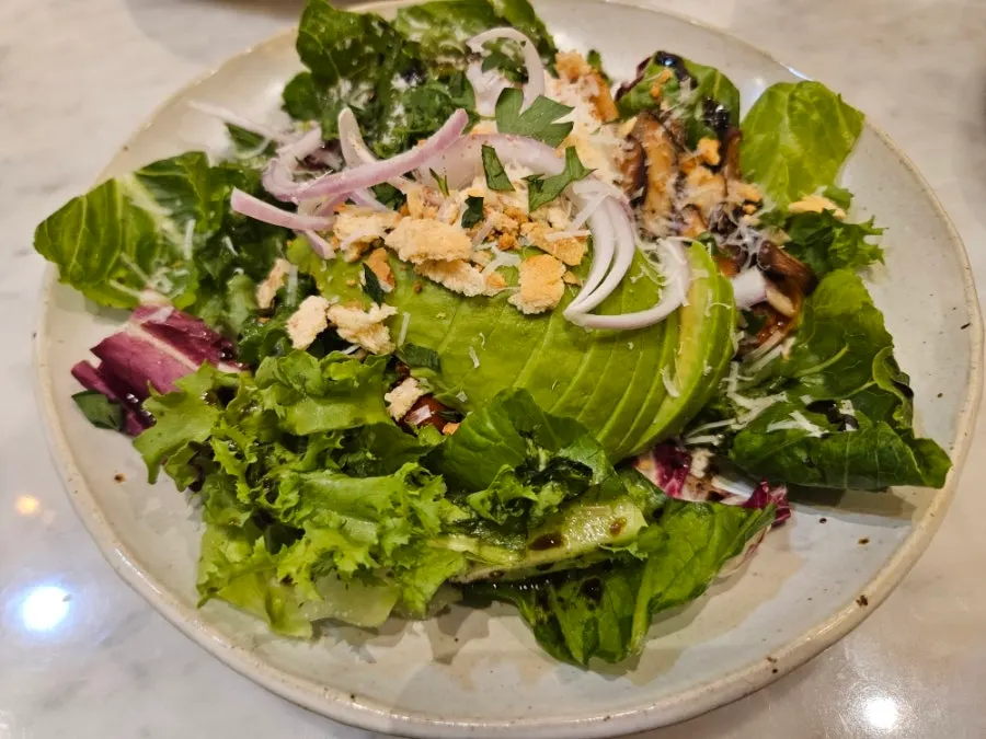 Plate of mushroom poached egg avocado salad