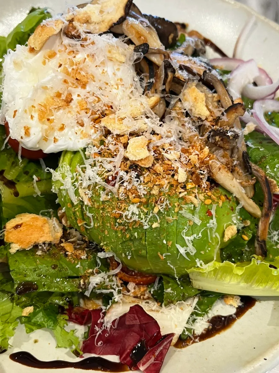 A plate of mushroom poached egg avocado salad