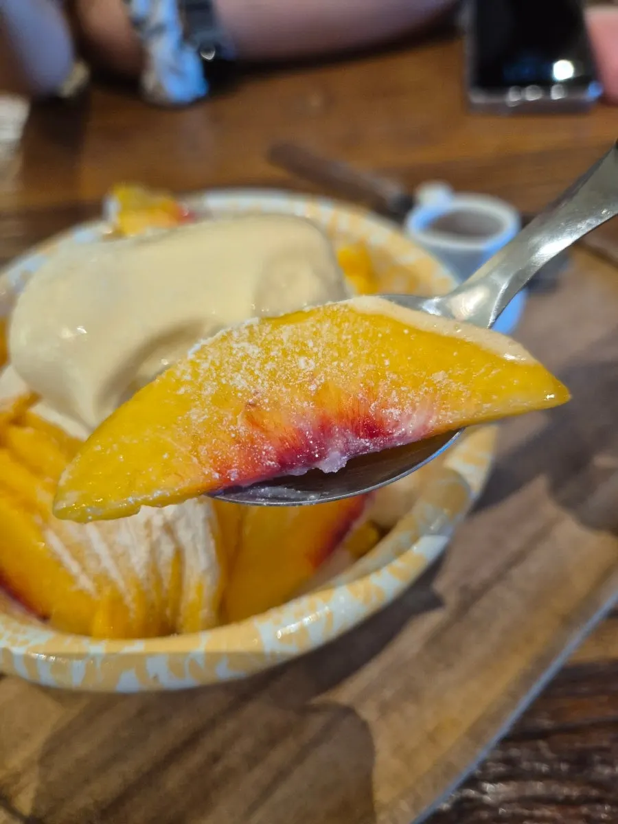 A spoonful of gelato on the peach bingsu