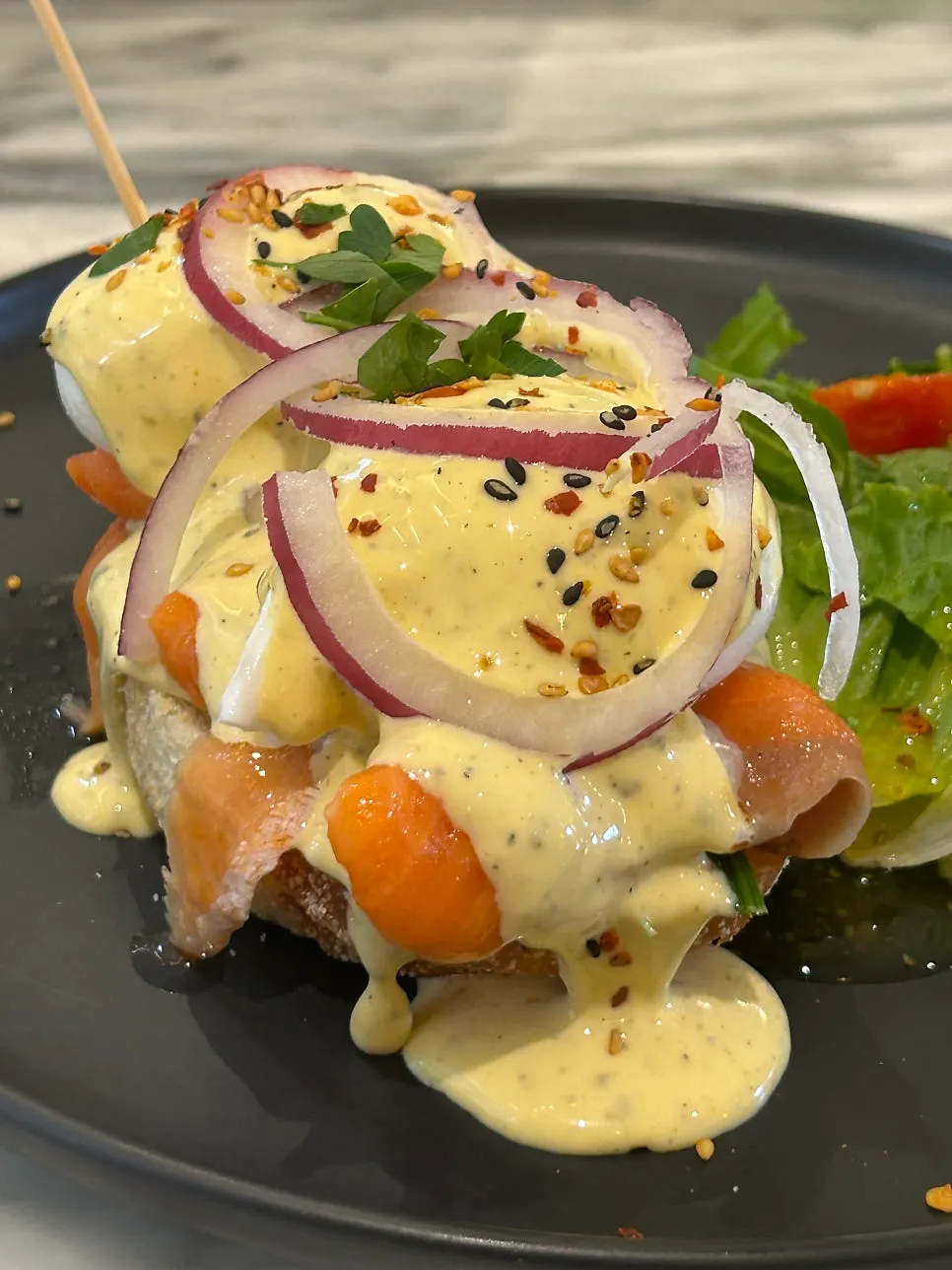 Salmon eggs Benedict topped with hollandaise sauce
