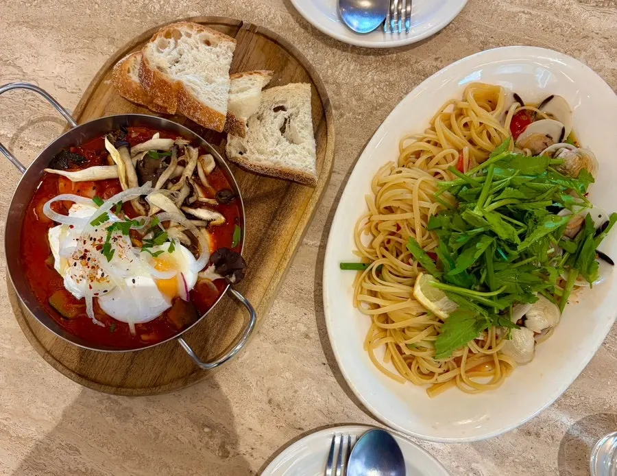Minari vongole pasta and shakshuka served together