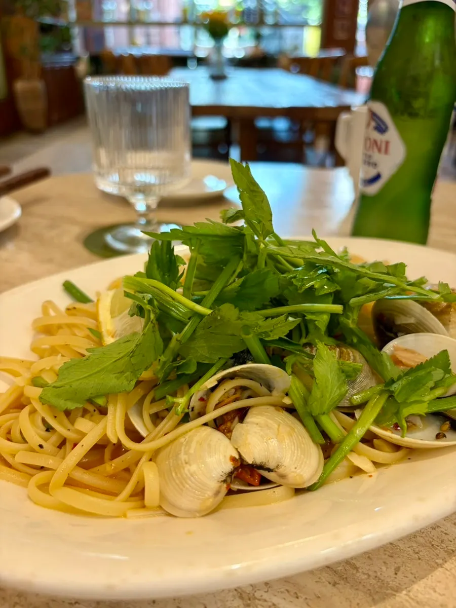 Vongole pasta topped with clams and minari