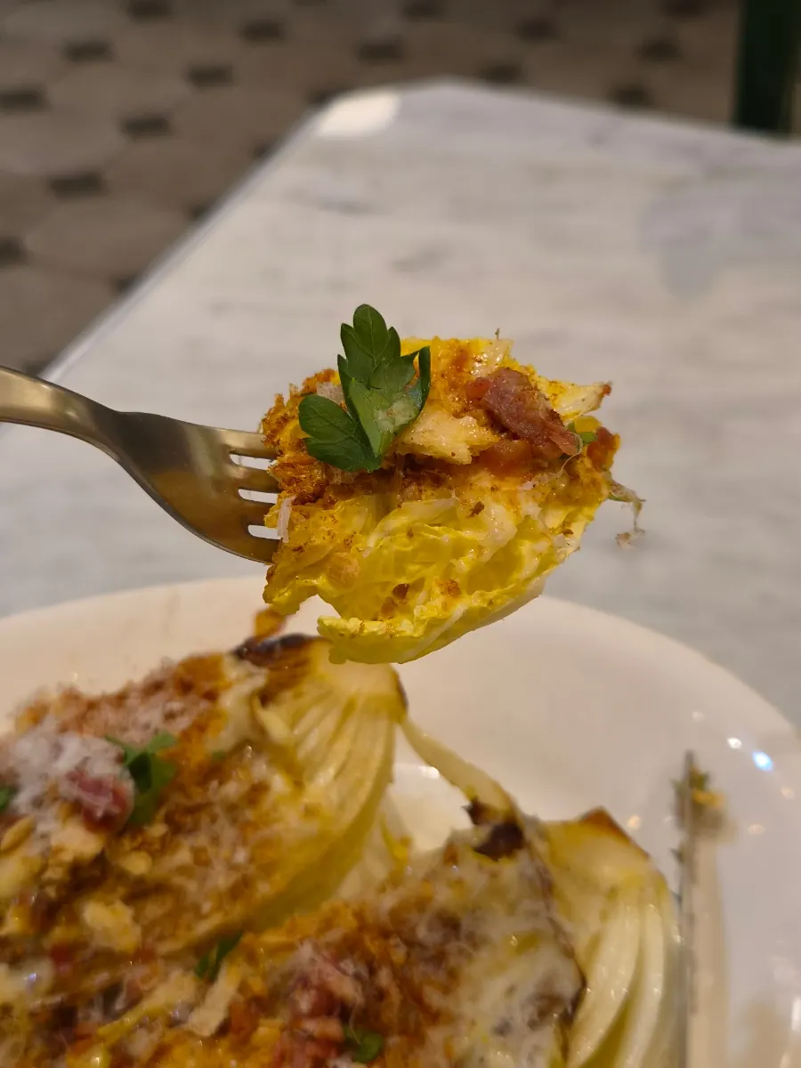 Close-up of napa cabbage salad topped with bacon bits