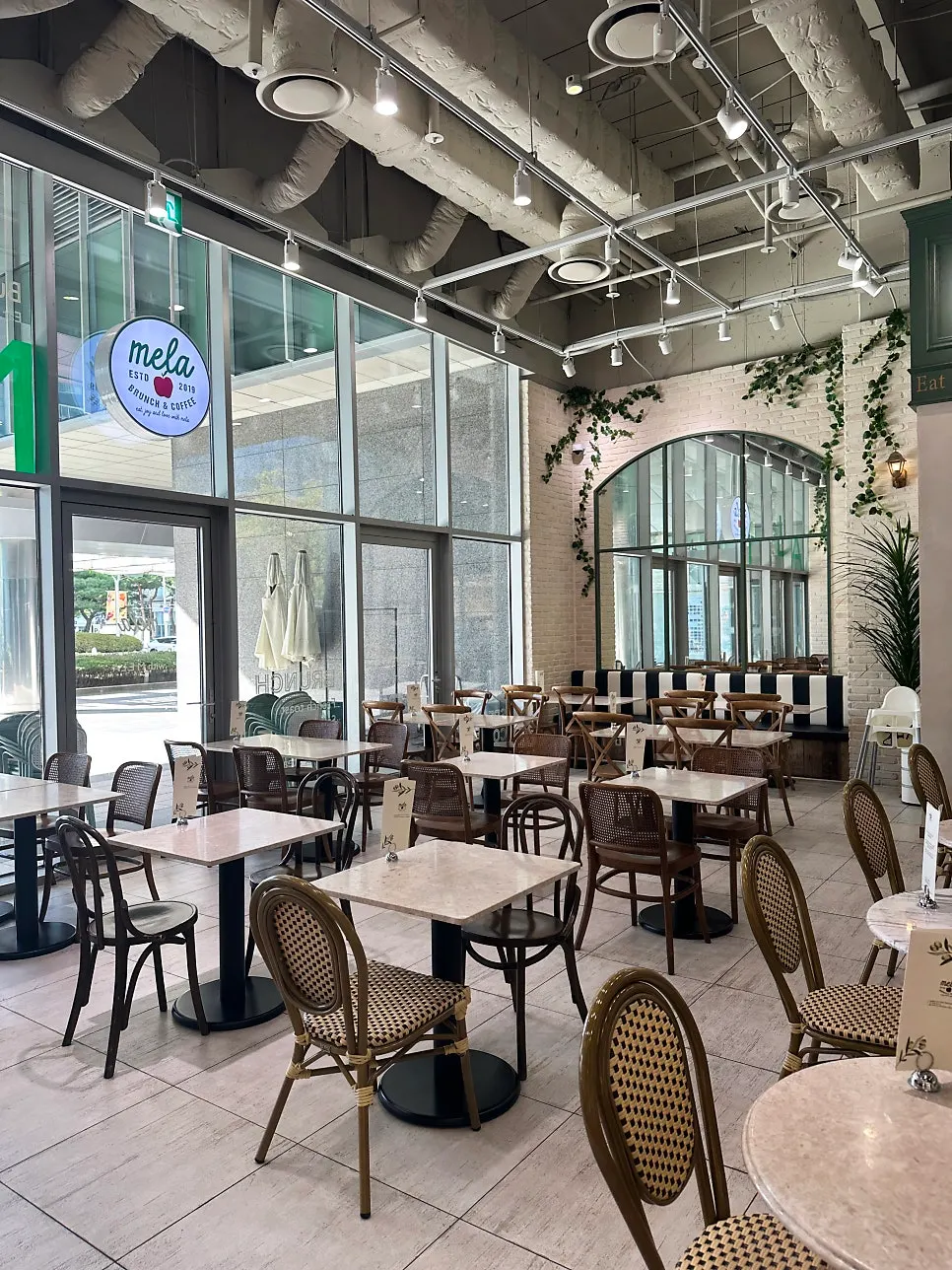 High-ceilinged interior of Mela Times Square