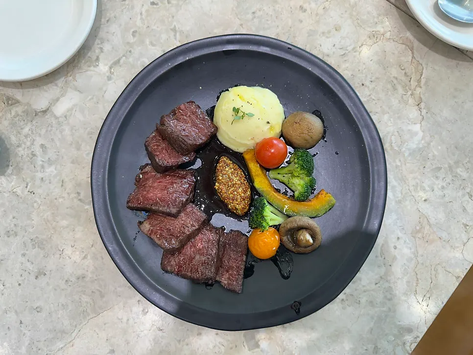 Table setting with Mela's chuck flap steak and cabbage salad