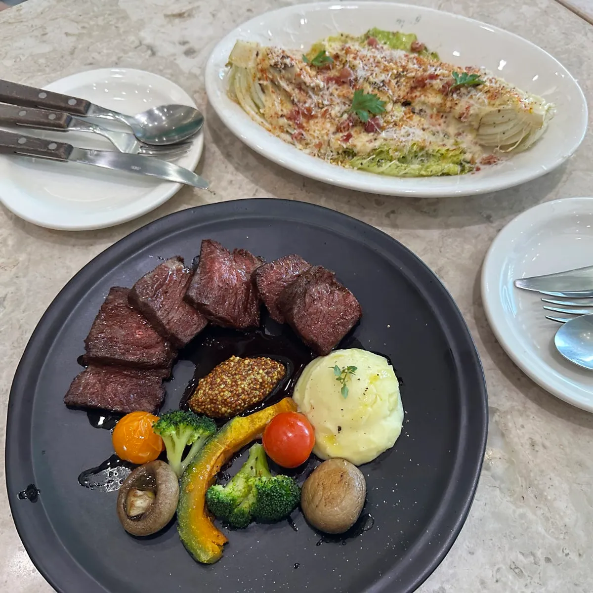 Full spread of steak and salad at Mela Times Square