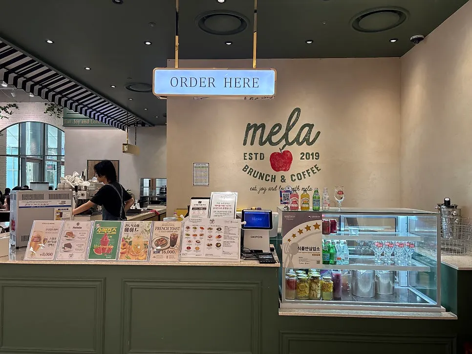 Overview of Mela's storefront with European home cooking concept