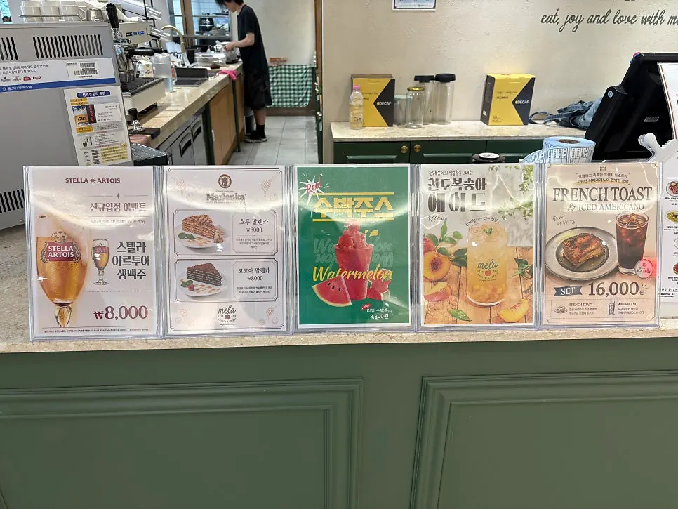 Menu signage listing Mela's signature dishes