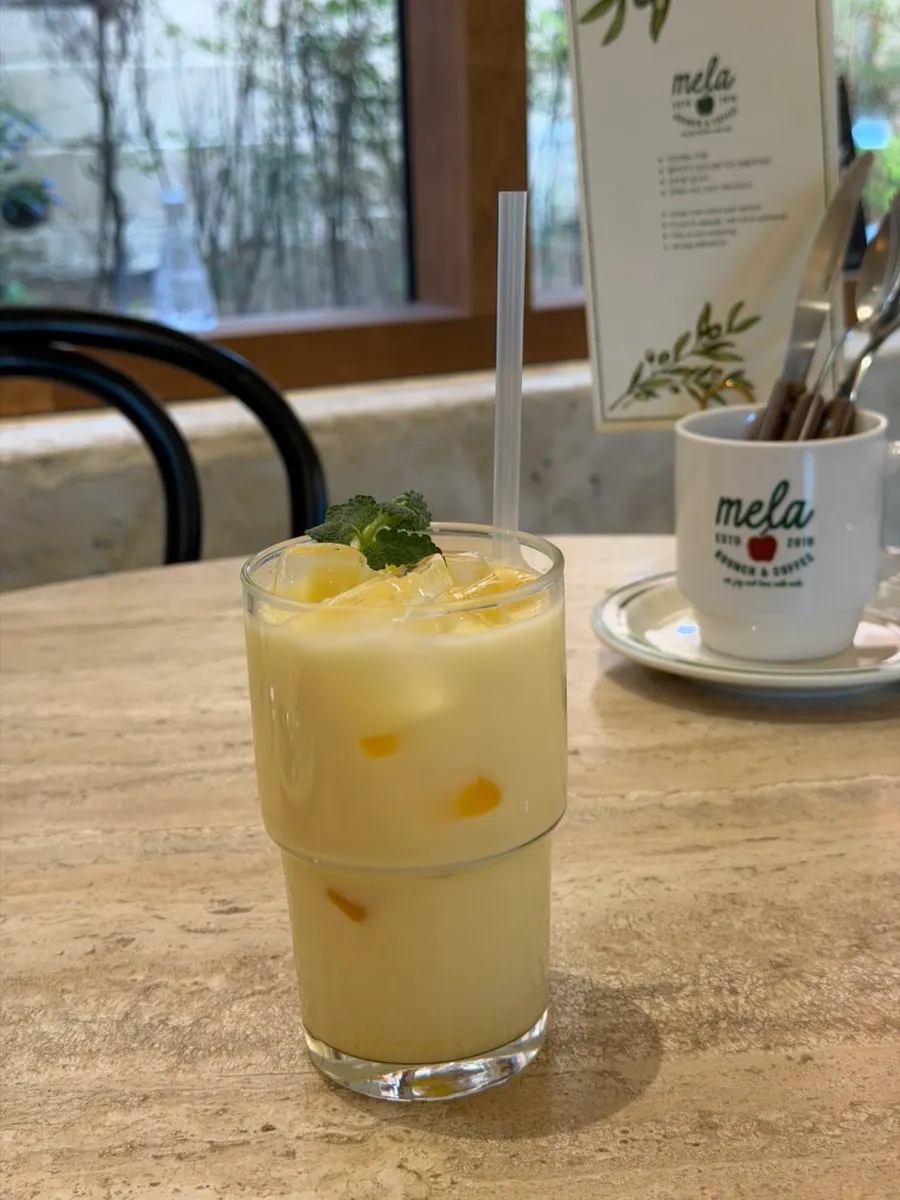 Mango latte on the table at MELA Hongdae
