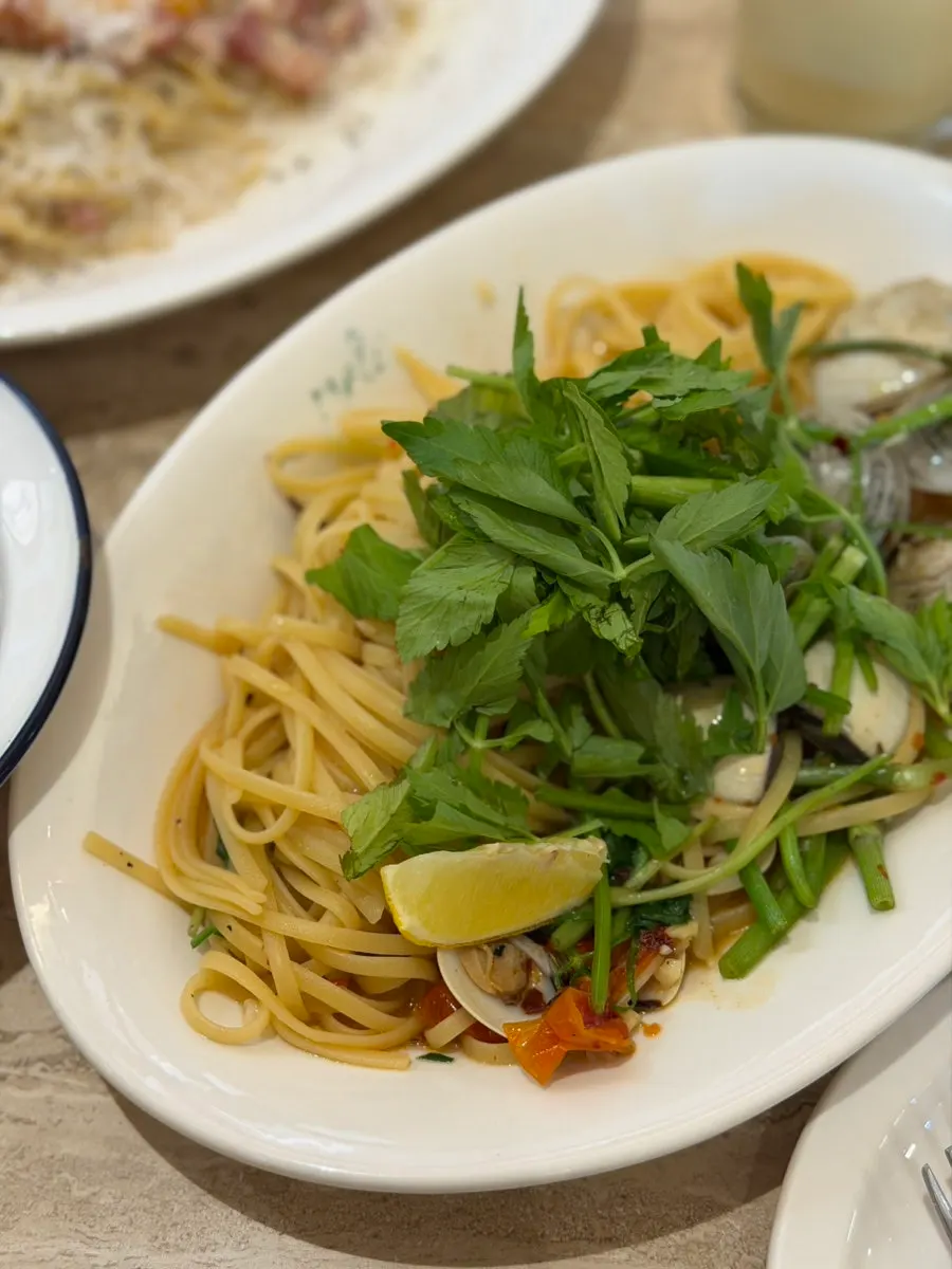 Close-up of vongole pasta with clams and minari