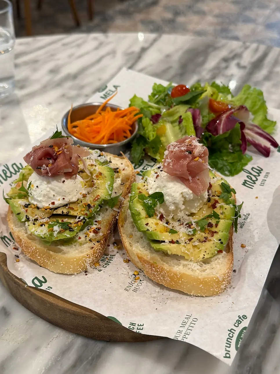 Avocado and jamón piled on bread
