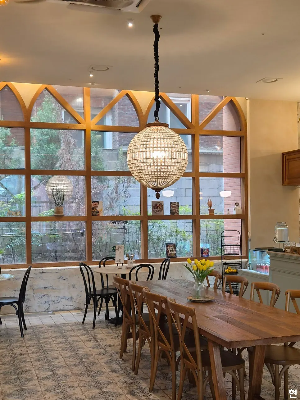 Interior of MELA Hongdae filled with wood-tone furniture