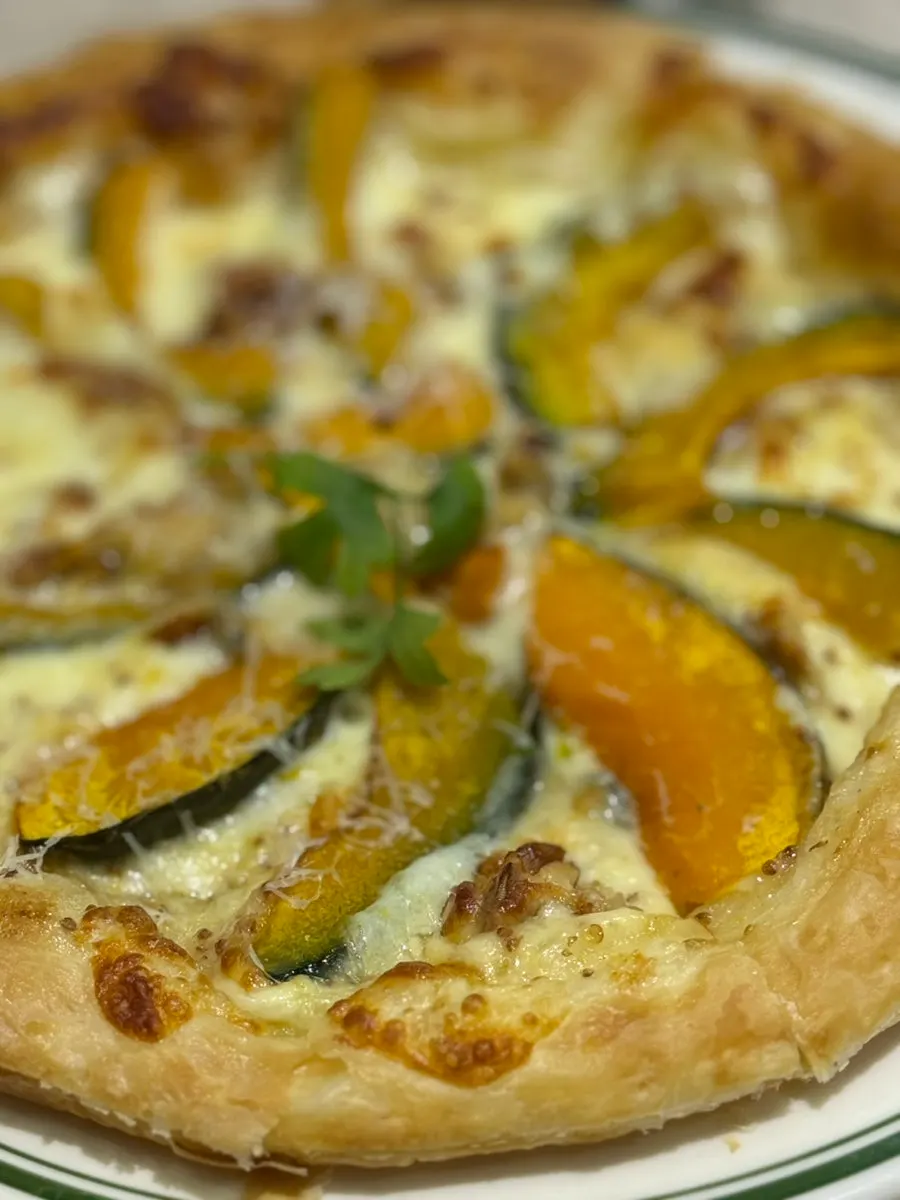 A slice of gorgonzola pastry pizza drizzled with honey
