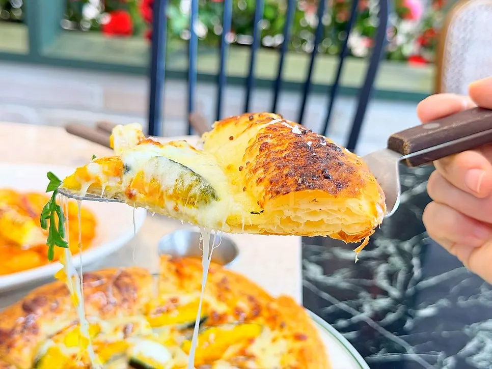 Slice of pumpkin pizza with honey on the side