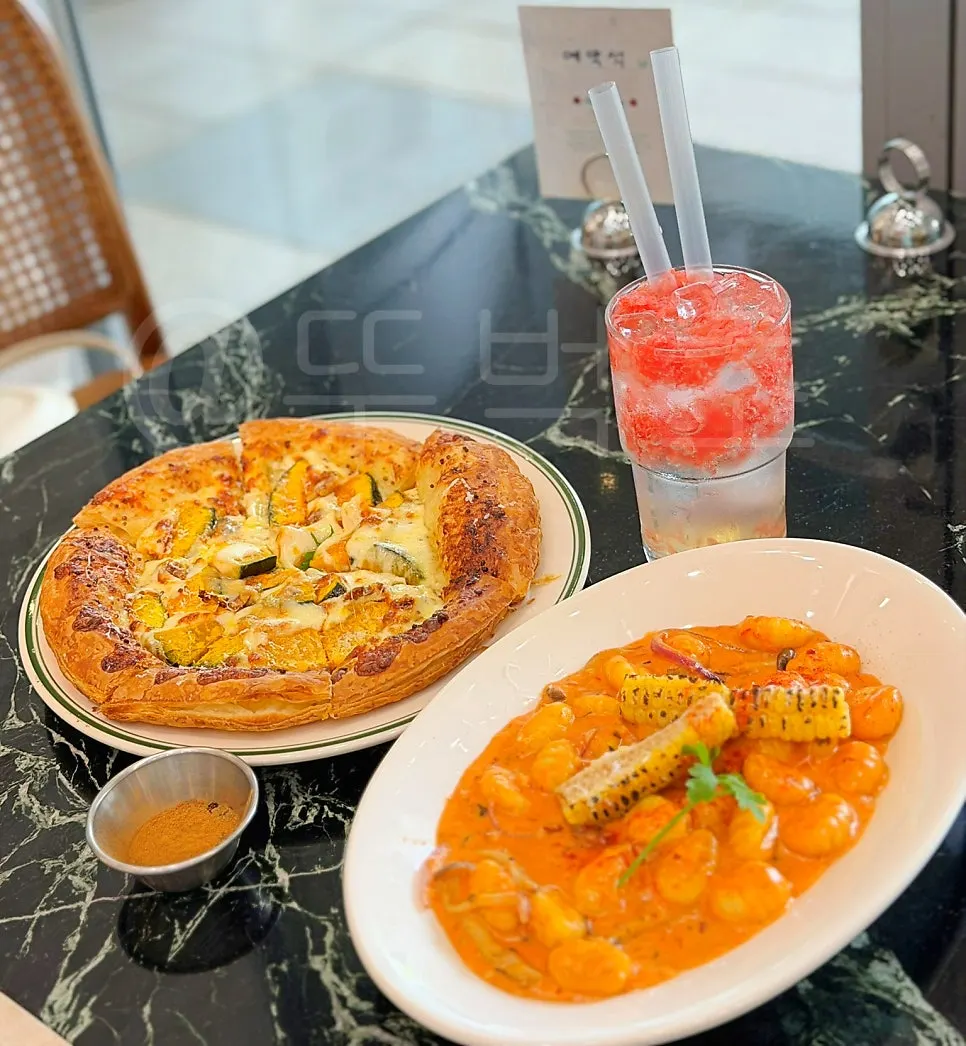 Table spread of Mela's rose corn gnocchi and pumpkin pizza