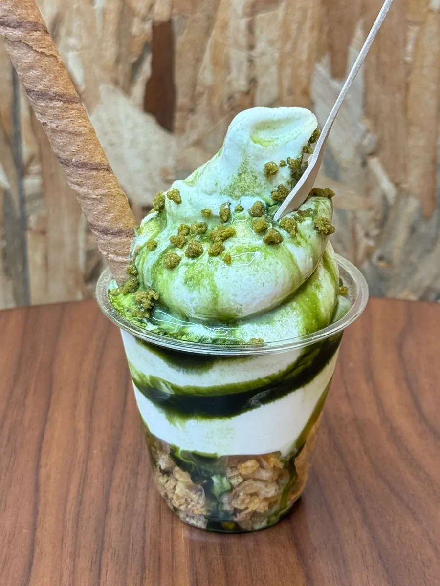 Matcha and mango soft serve ice cream served together