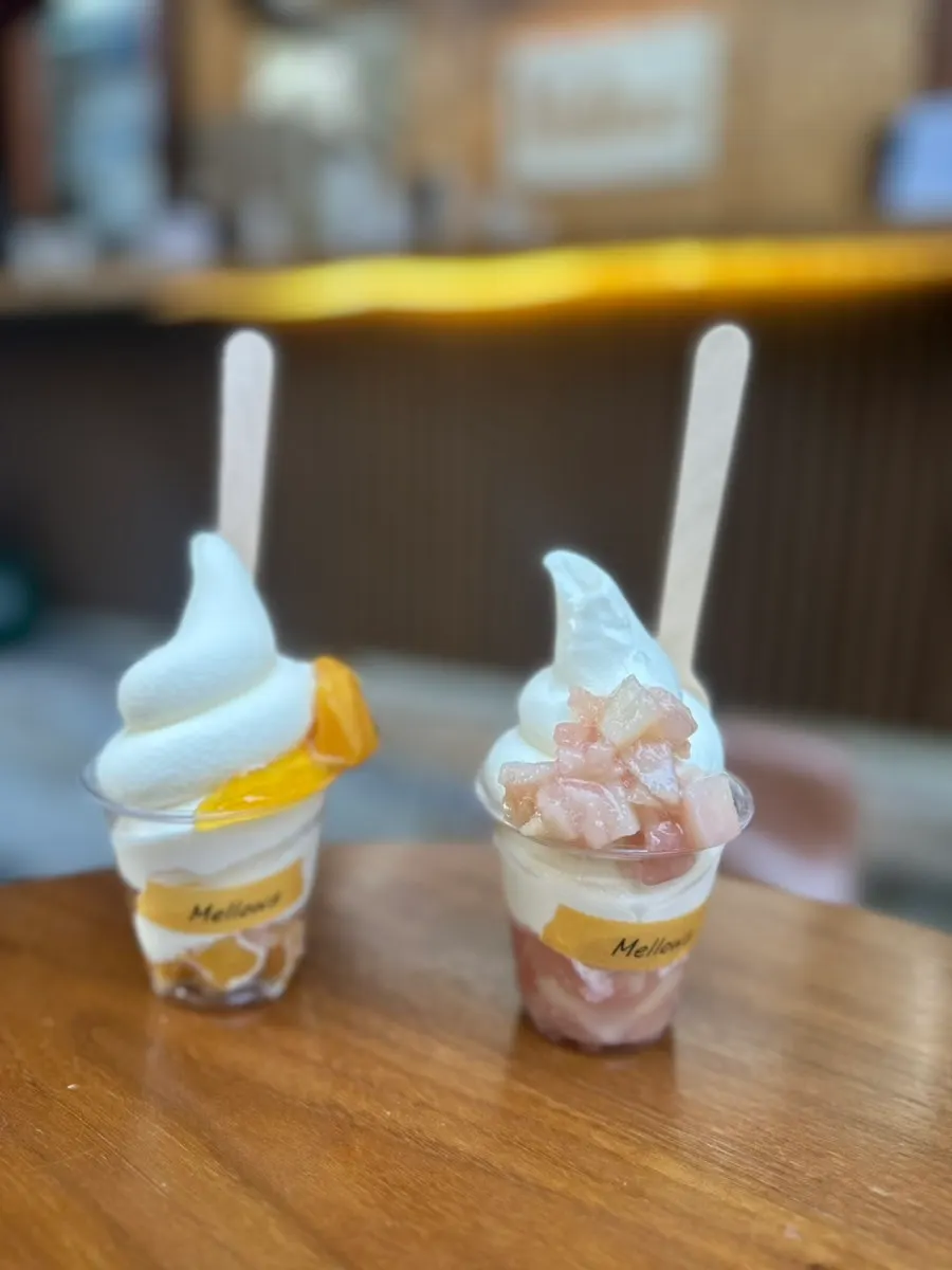Mango and peach soft serve held side by side