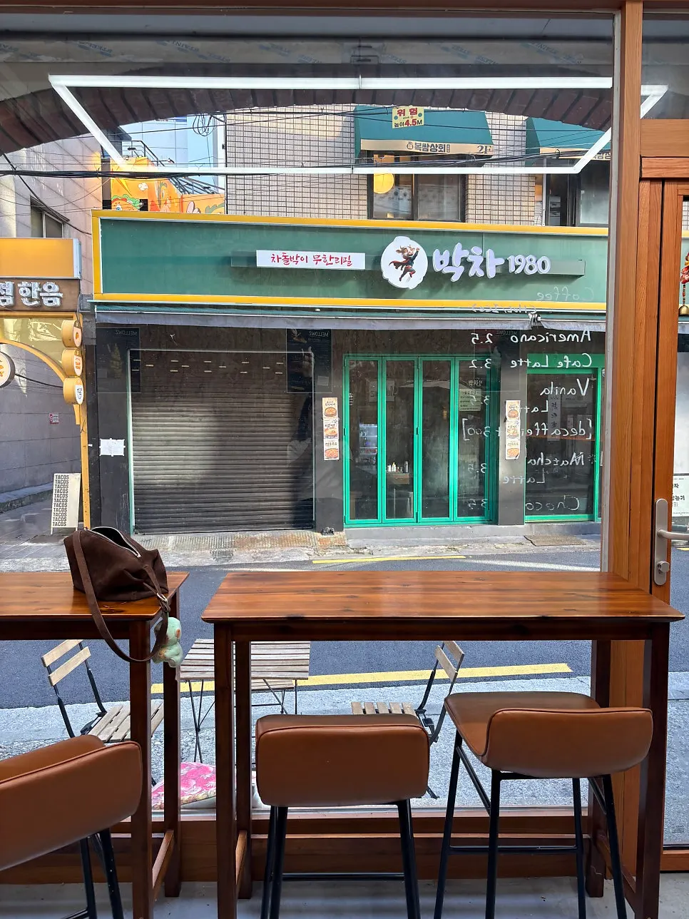 Window bar seats next to a large glass window