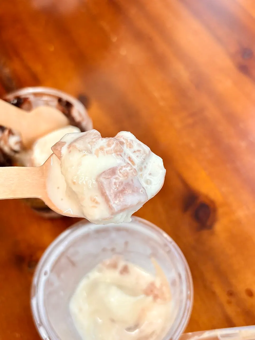 A spoonful scooped out of the peach ice cream