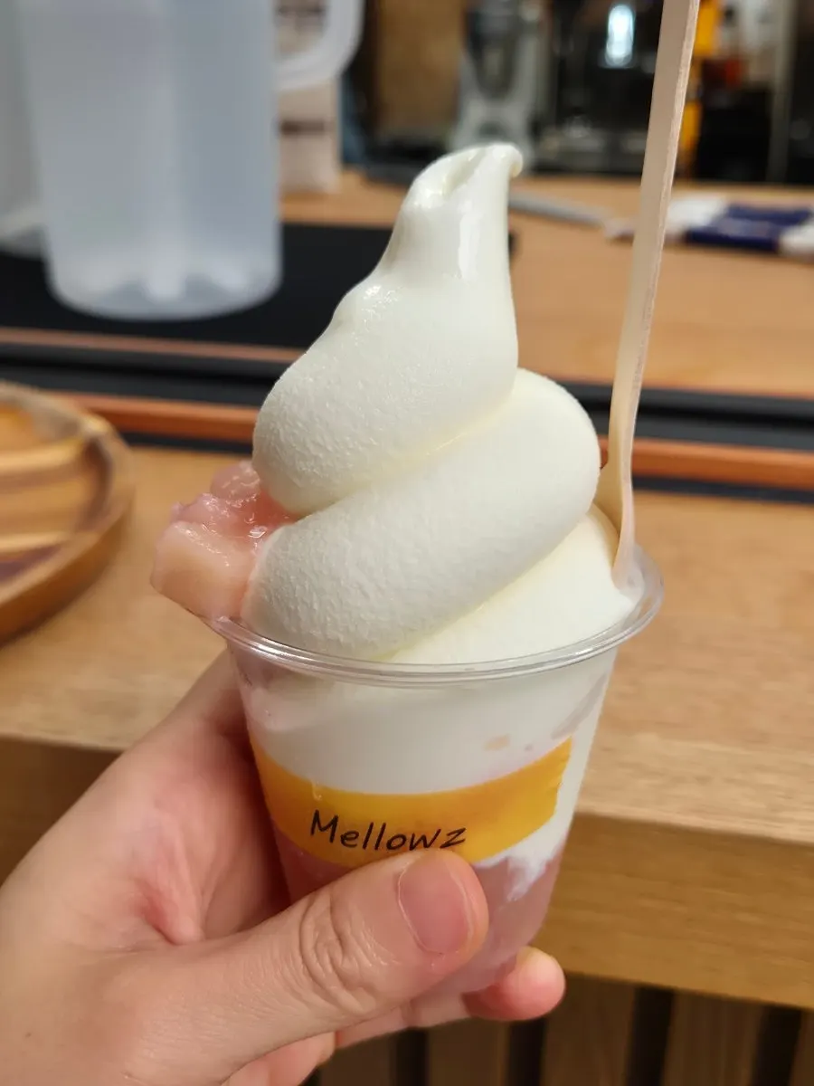 Peach ice cream topped with stewed peaches