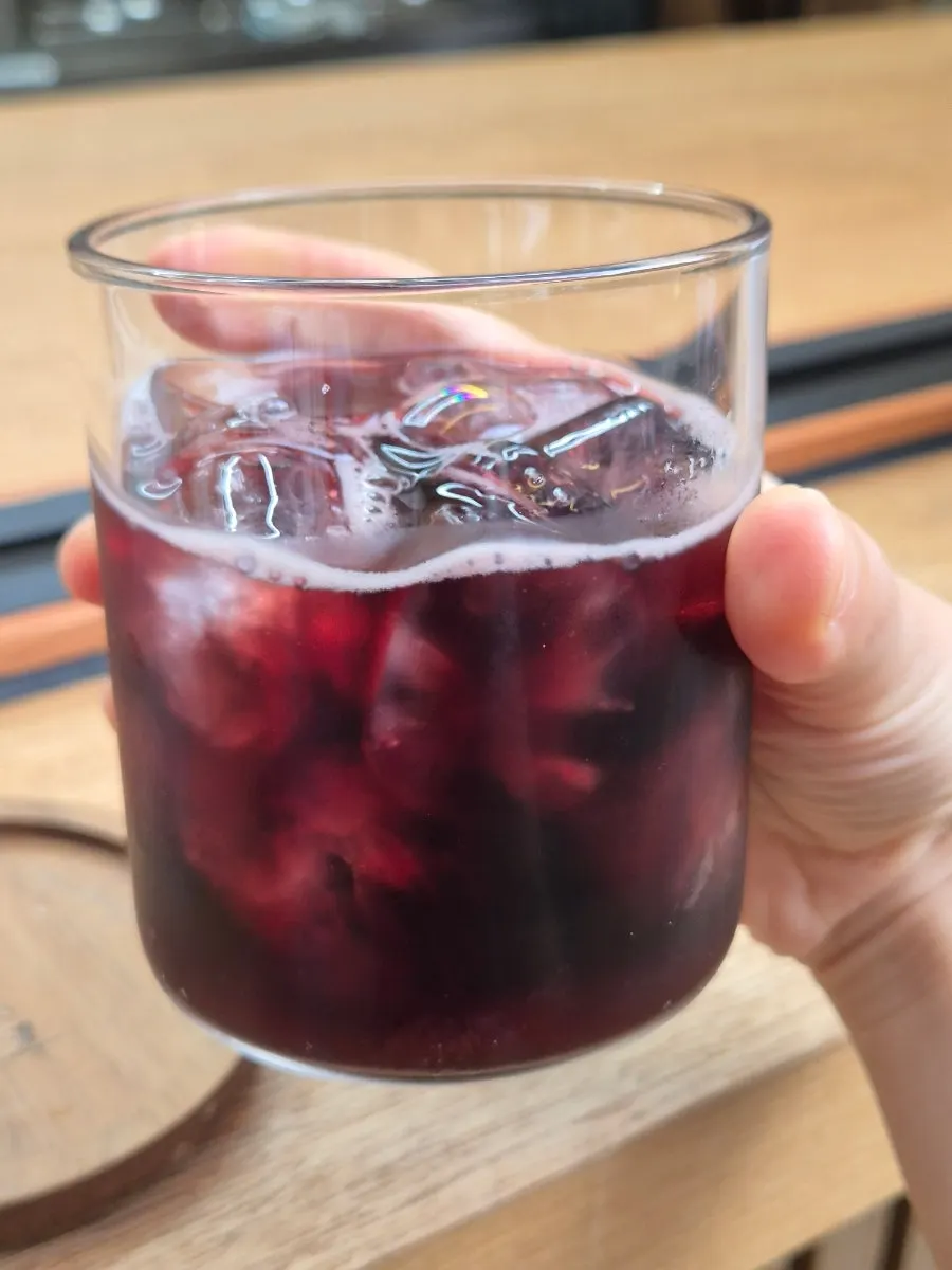 A glass of kalimotxo, red wine mixed with zero-sugar cola