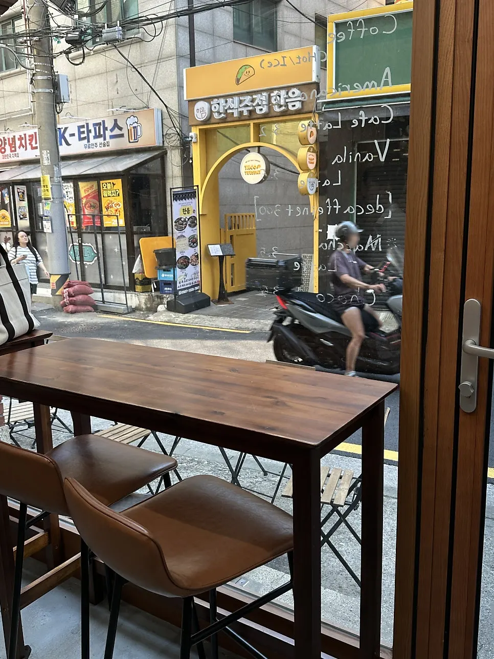 Bar table by the full-length window and round table seating