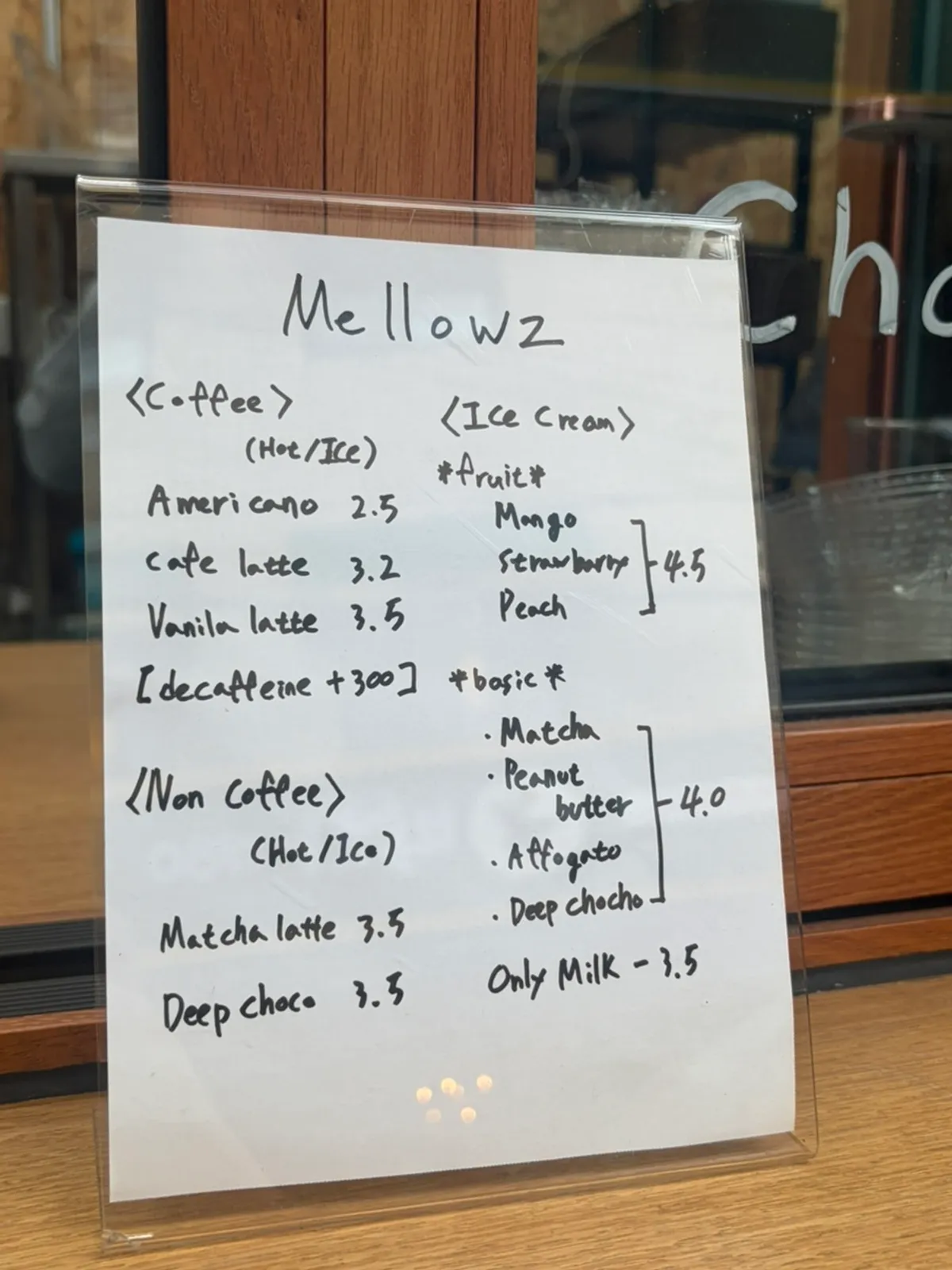 Menu board listing americano and ice cream prices